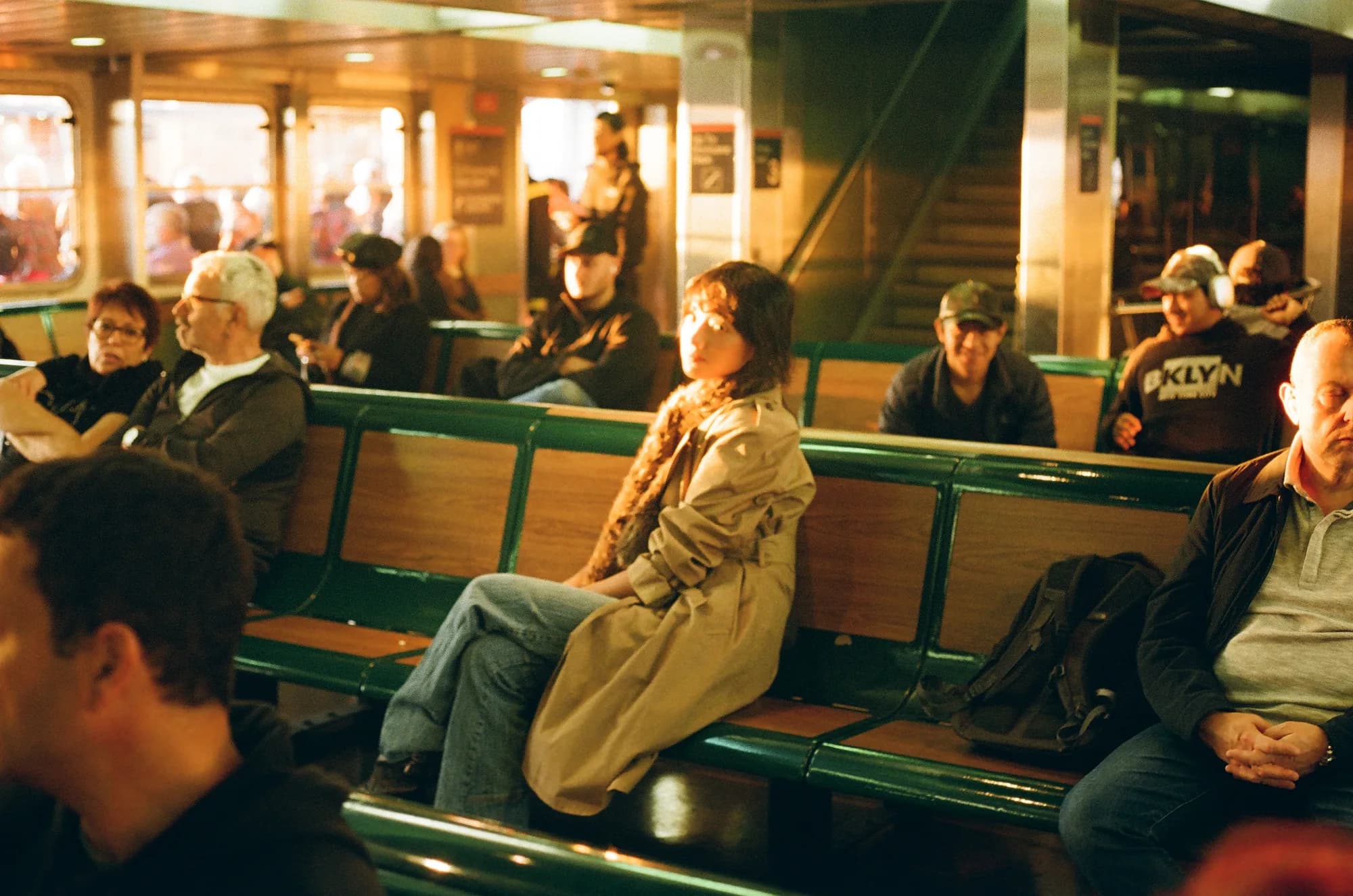 Passengers in a golden ferry cabin.