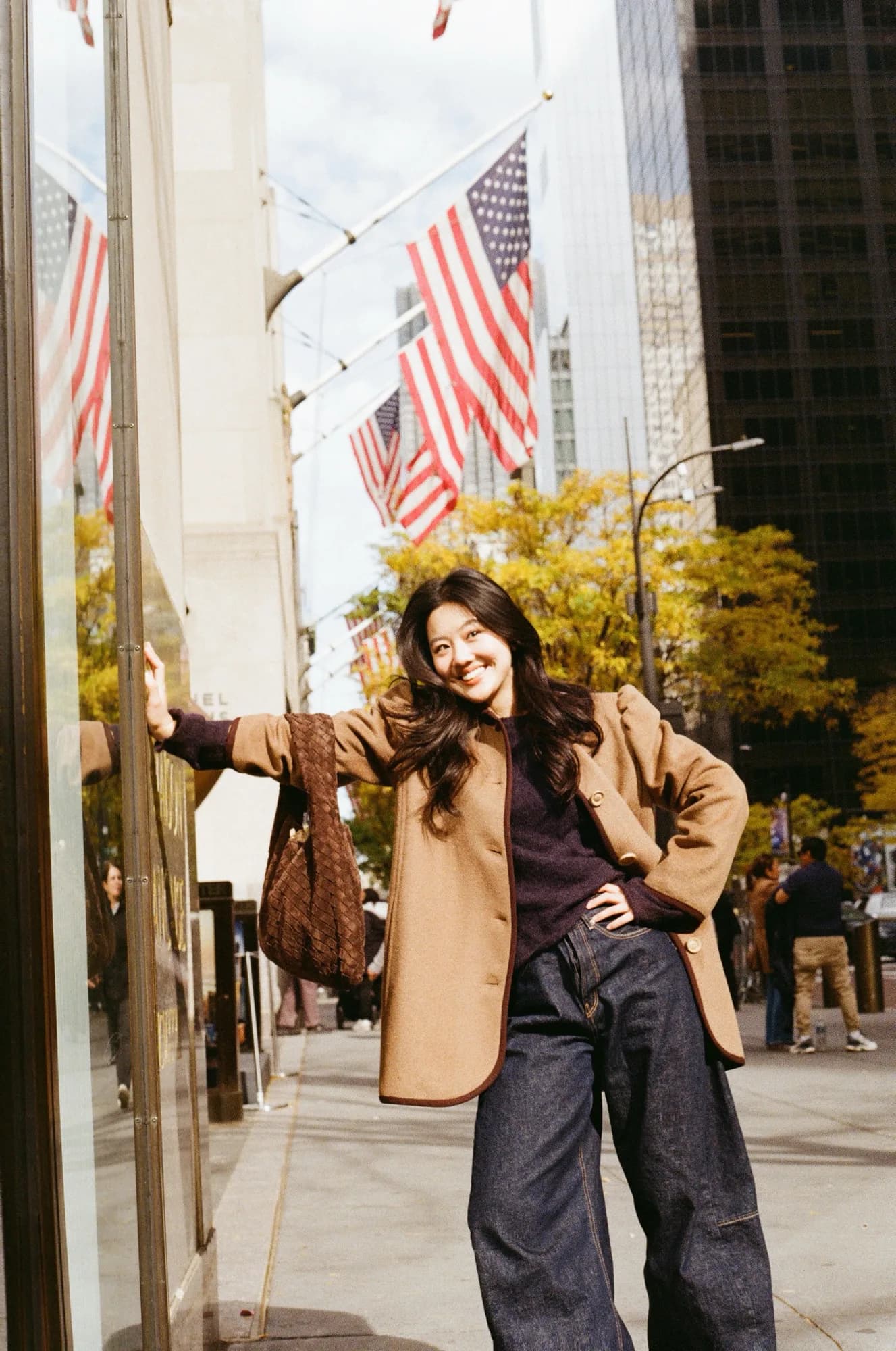 A brown coat on a sunlit street.