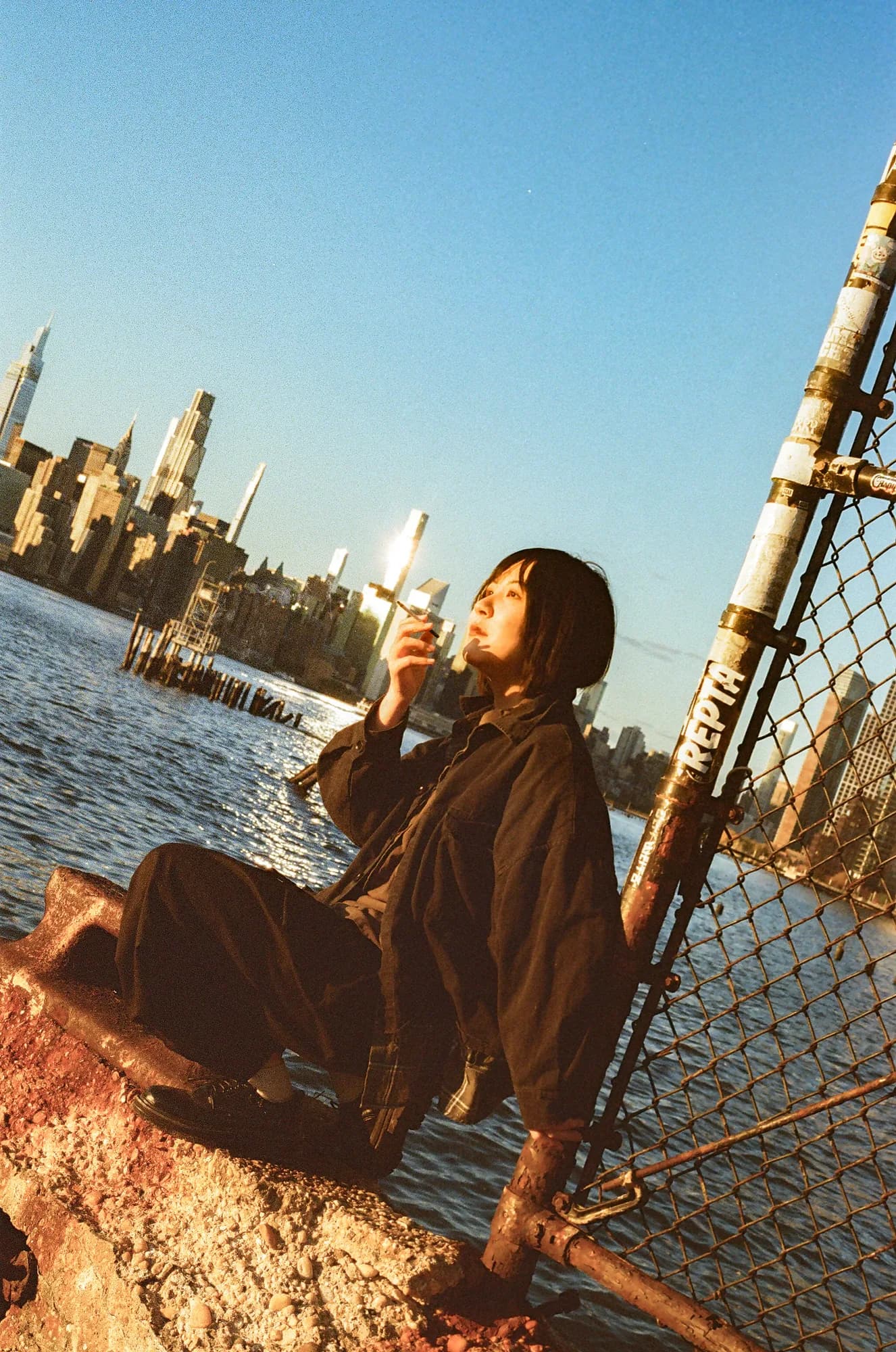 A waterfront portrait in warm sunlight.