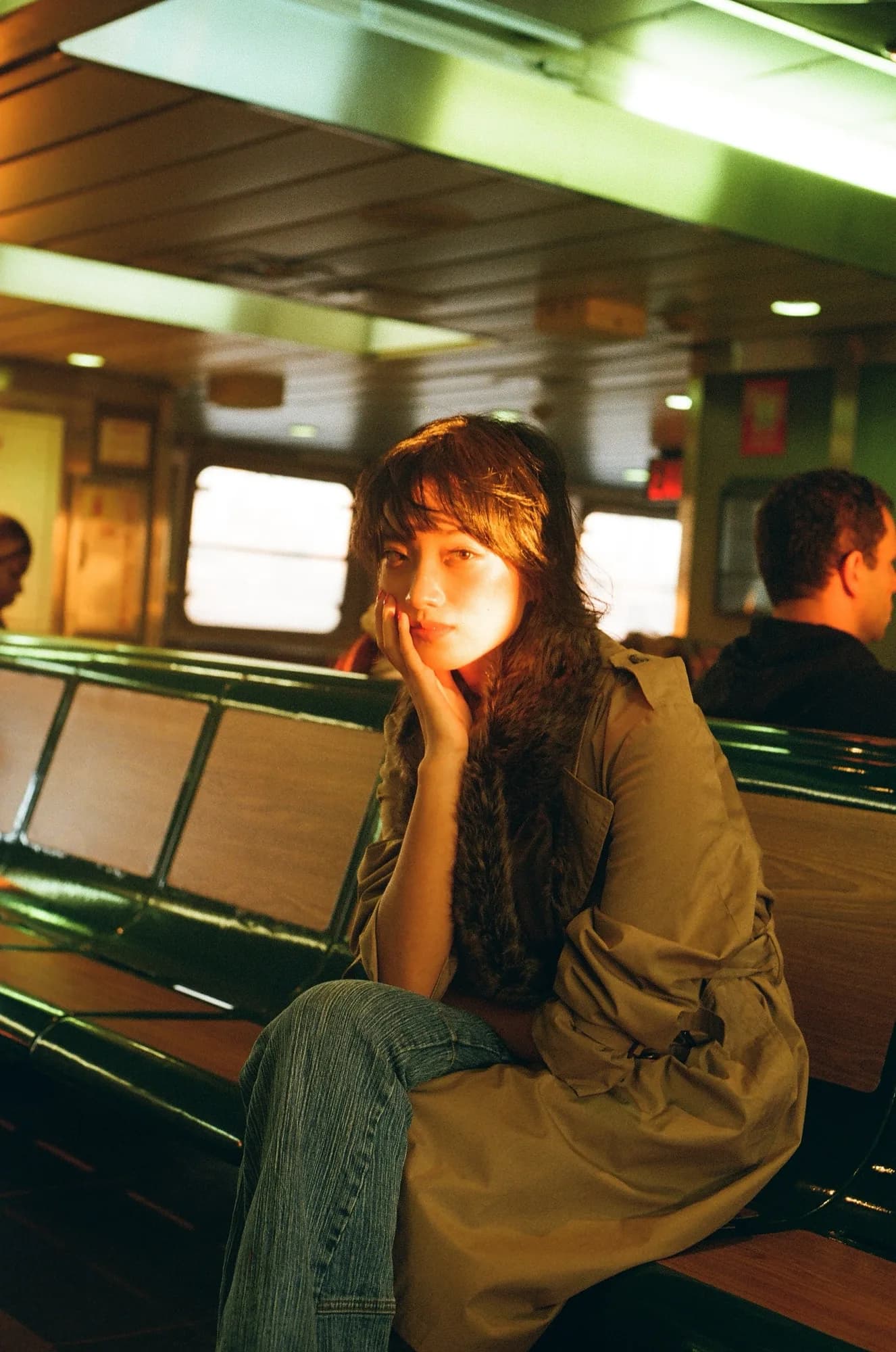 A portrait in an amber ferry cabin.