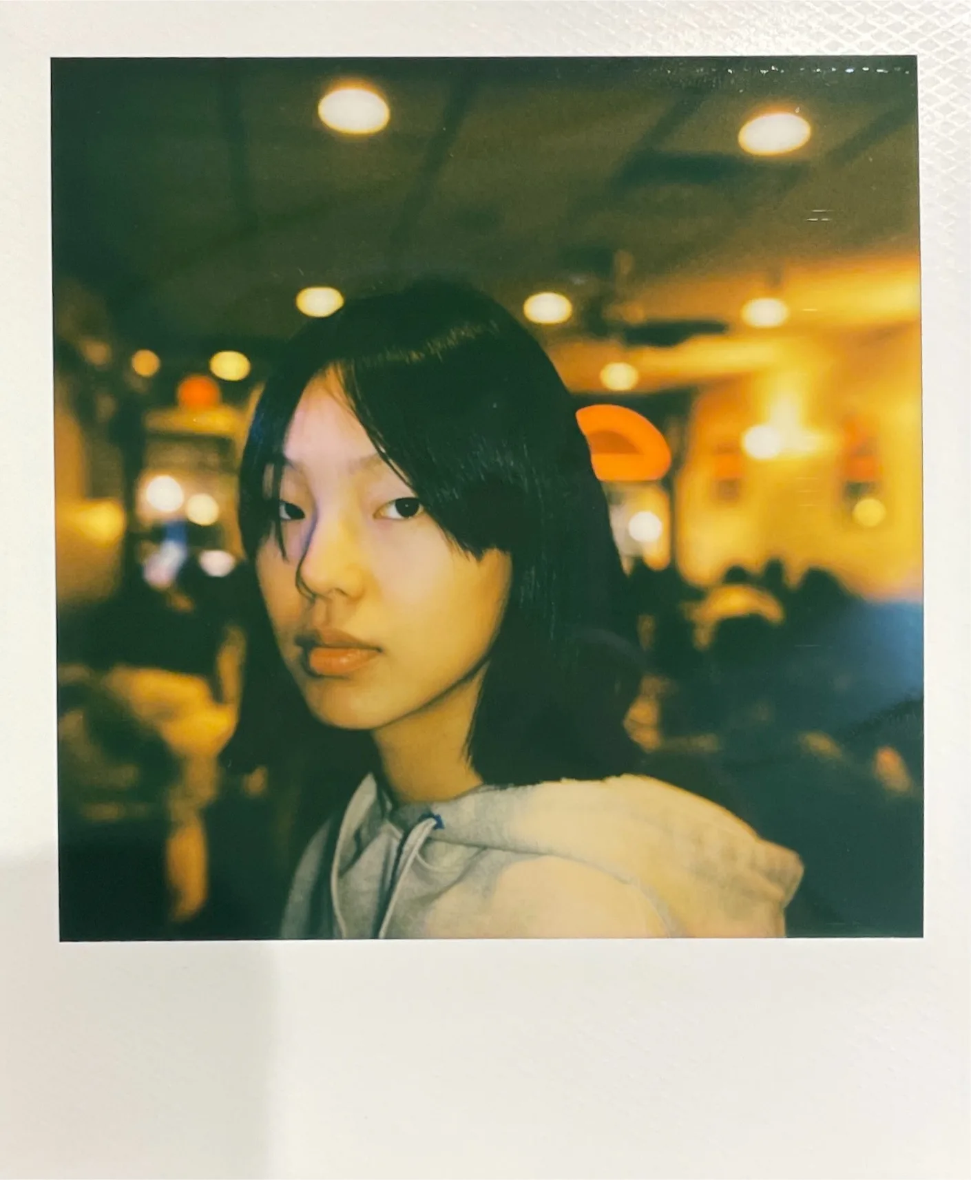 An instant portrait among green and amber lights.